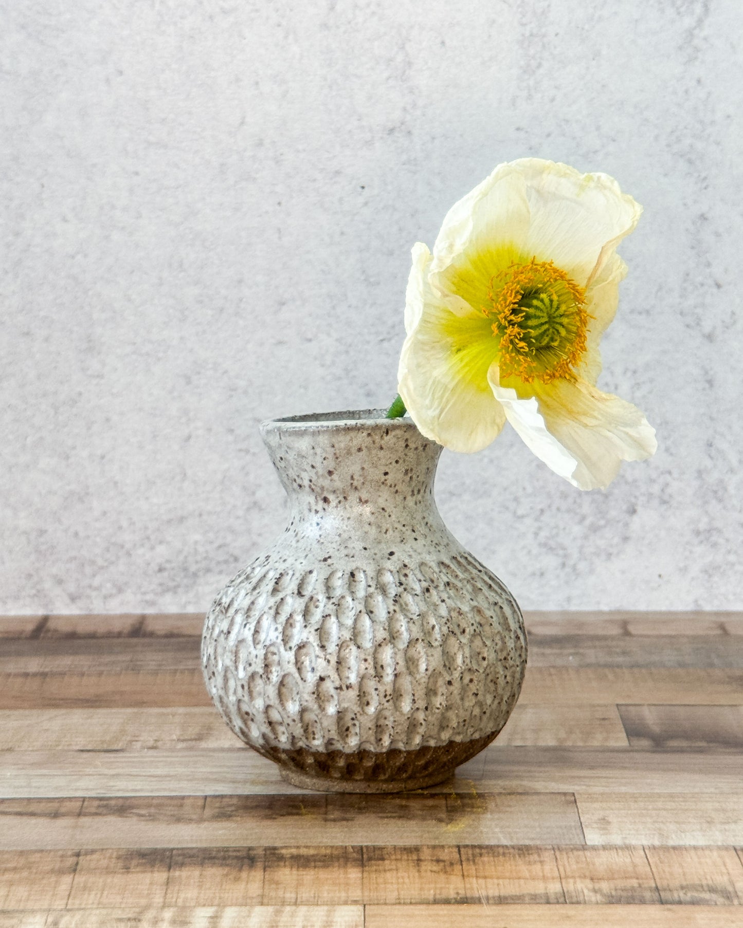 small carved speckled bud vase