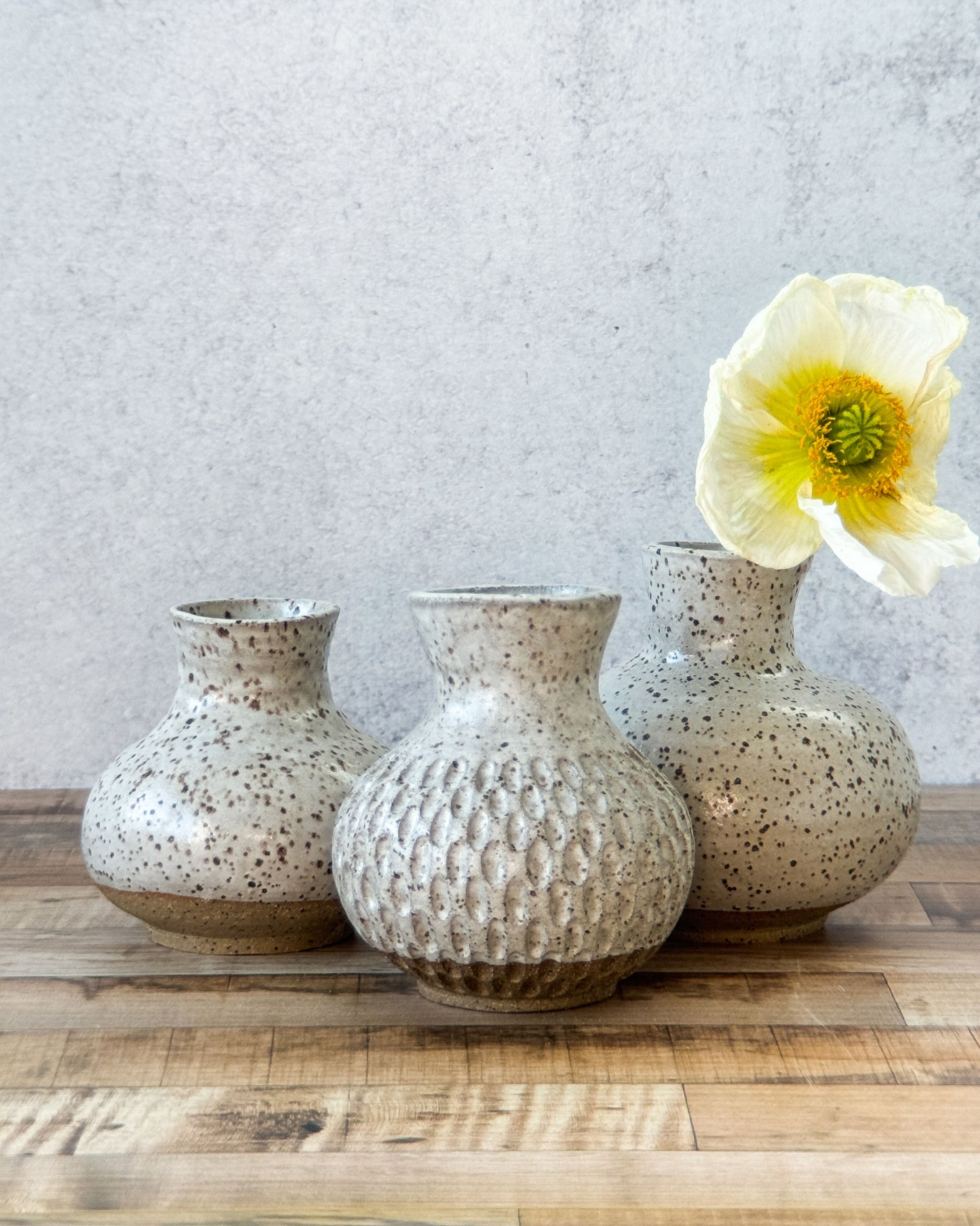 small carved speckled bud vase